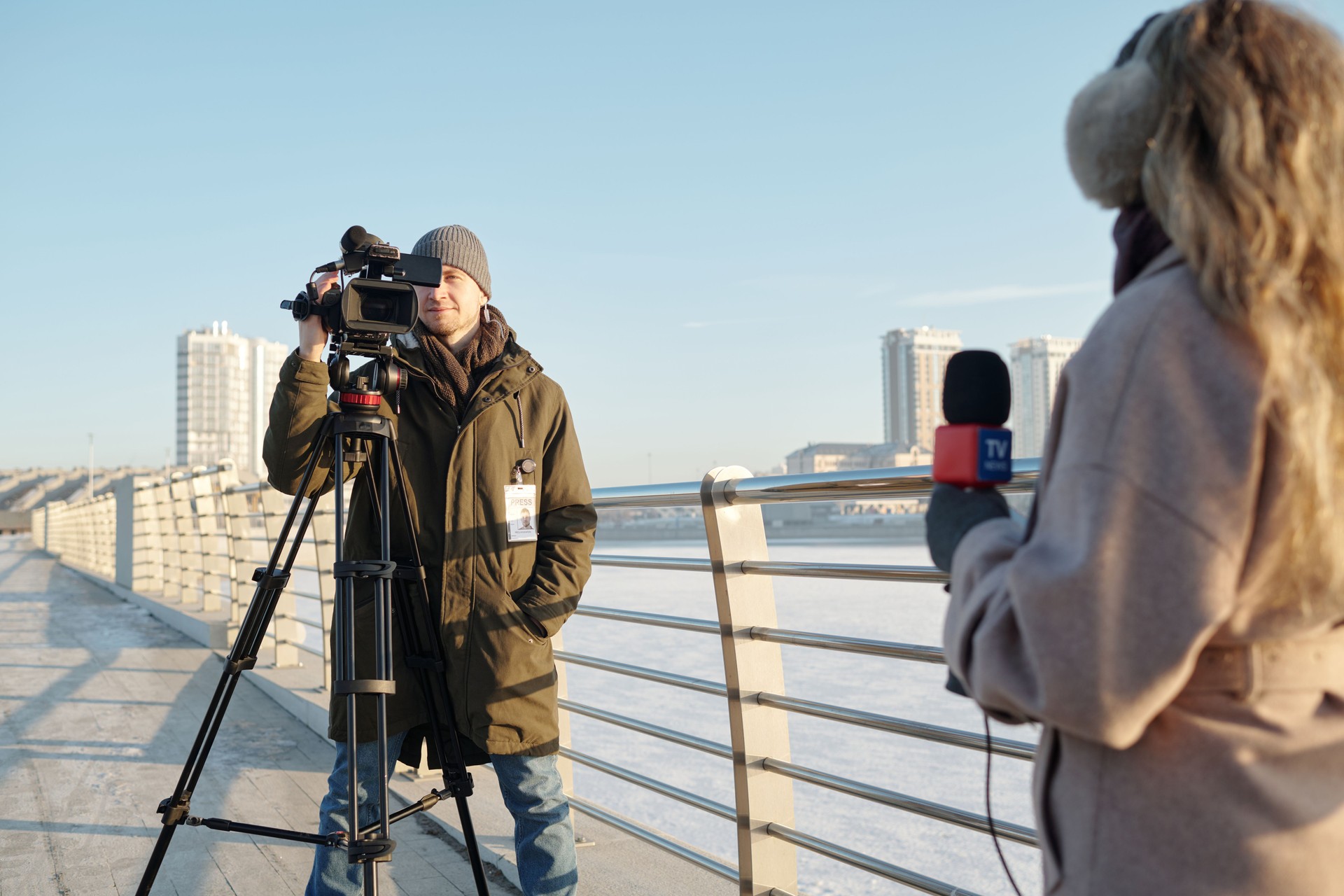 Operator using professional video camera Operator using professional video camera